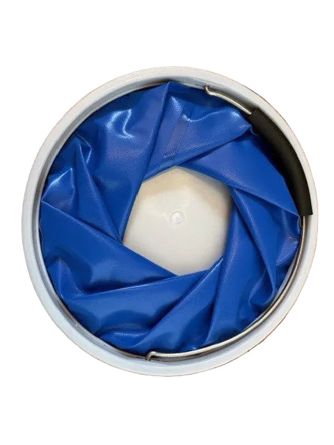 Blue folding bucket collapsed flat, with PVC sides folded inside the circular rim and handle tucked down.