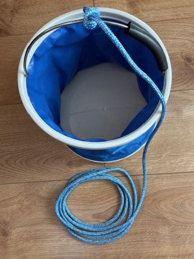 Blue 9 litre PVC folding bucket viewed from above, with open interior, metal handle and coiled blue lanyard.