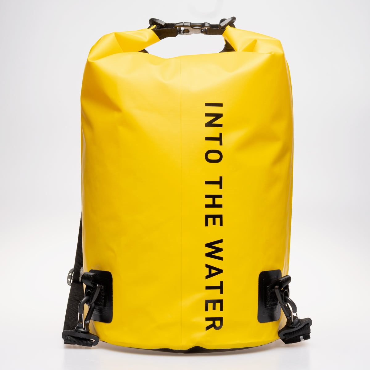 Rear view of the yellow GUL Drypac 25L dry bag with ‘Into the Water’ lettering