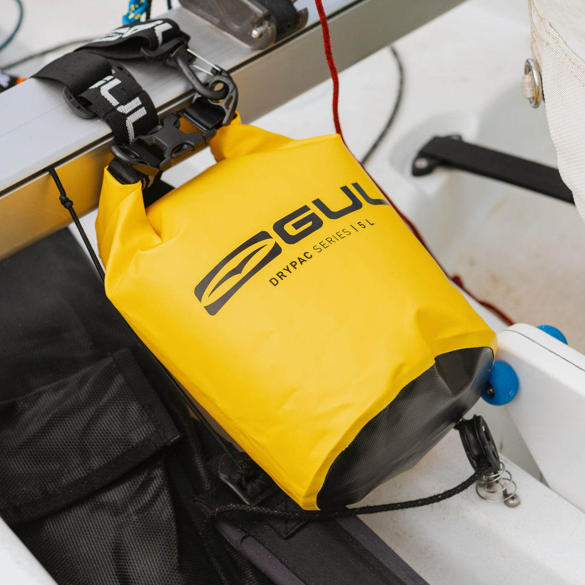 Yellow GUL Drypac 5L dry bag clipped inside a sailing dinghy1.