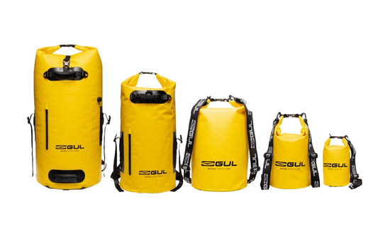Five yellow GUL Drypac dry bags in sizes from 5L to 100L.