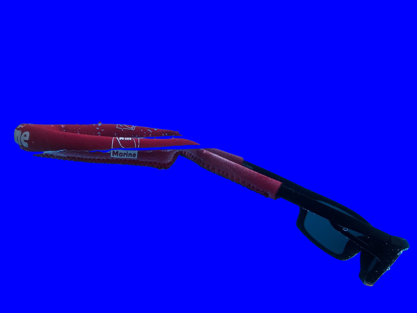 Neoprene floating strap keeping sunglasses afloat in water
