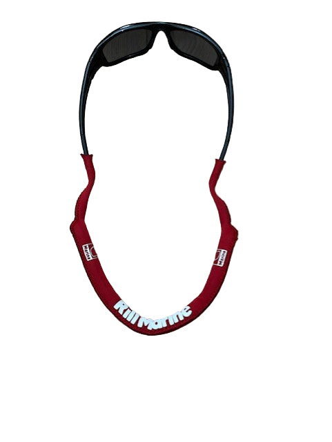 Red floating glasses strap attached to sunglasses worn around neck