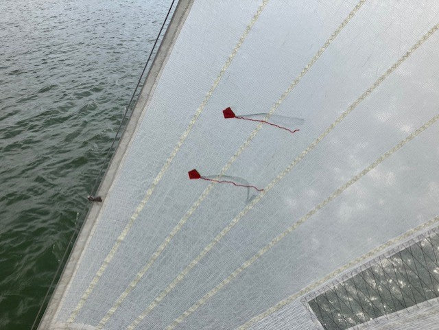 Sail tell tales in use on yacht sail showing wind flow indication