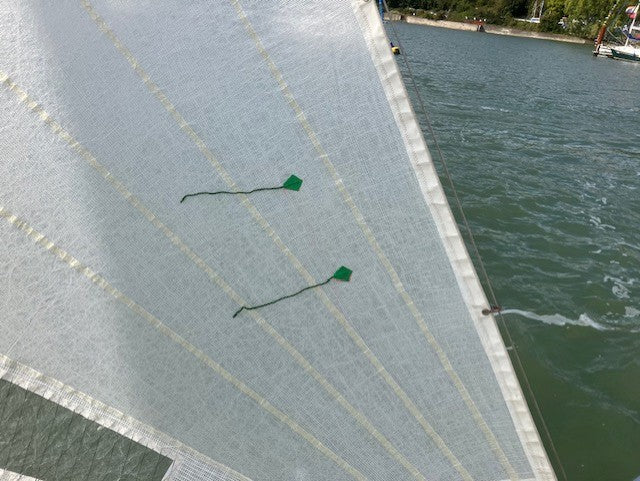 Tell tales on sail demonstrating proper sail trim while sailing