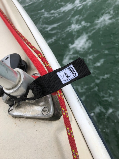 Spinnaker halyard keeper securing sail lines on yacht